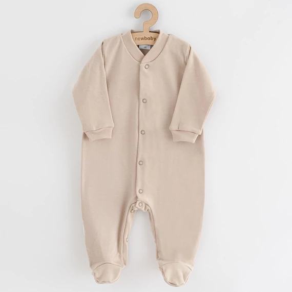 New Baby bézs kezeslábas 86-os méretben, 100% pamut, patentos záródással a könnyű öltöztetésért.
